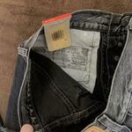 Levi's black denim shorts with button fly and raw hem is being swapped online for free